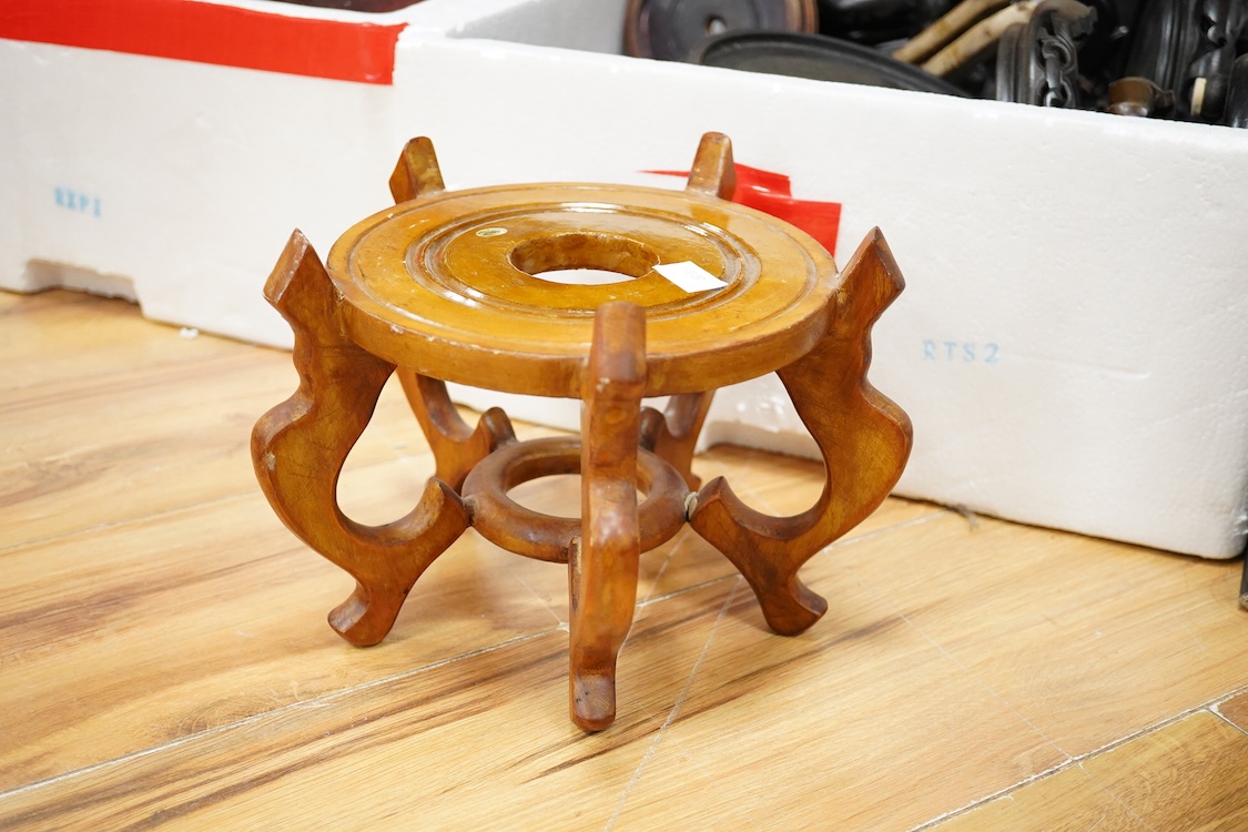 A large collection of Chinese hardwood stands, including a pair 24cm diameter x 18cm high